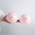 a person holding pink balloons