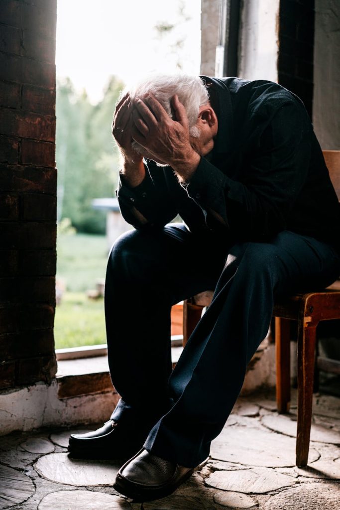 man sitting on brown woden chair